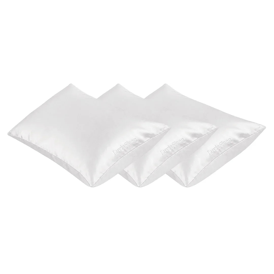Set of three white 25-momme mulberry silk pillowcases for hair and skin care.