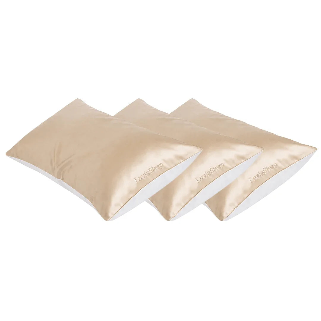 Set of three champagne gold 25-momme mulberry silk pillowcases for hair and skin care.