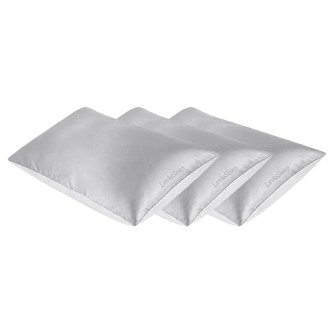 Set of three silver 25-momme mulberry silk pillowcases for hair and skin care.